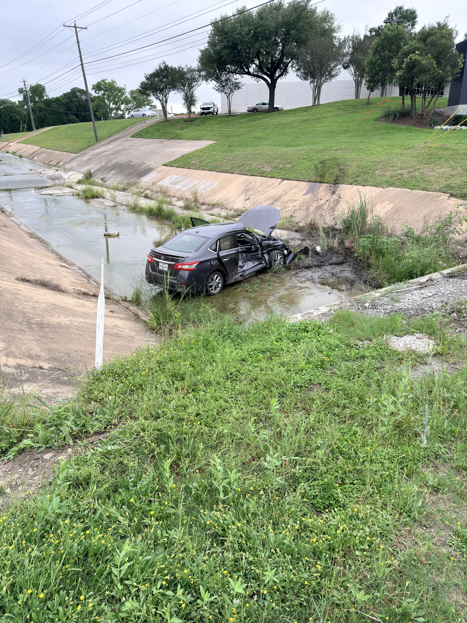 Car in canal from far side